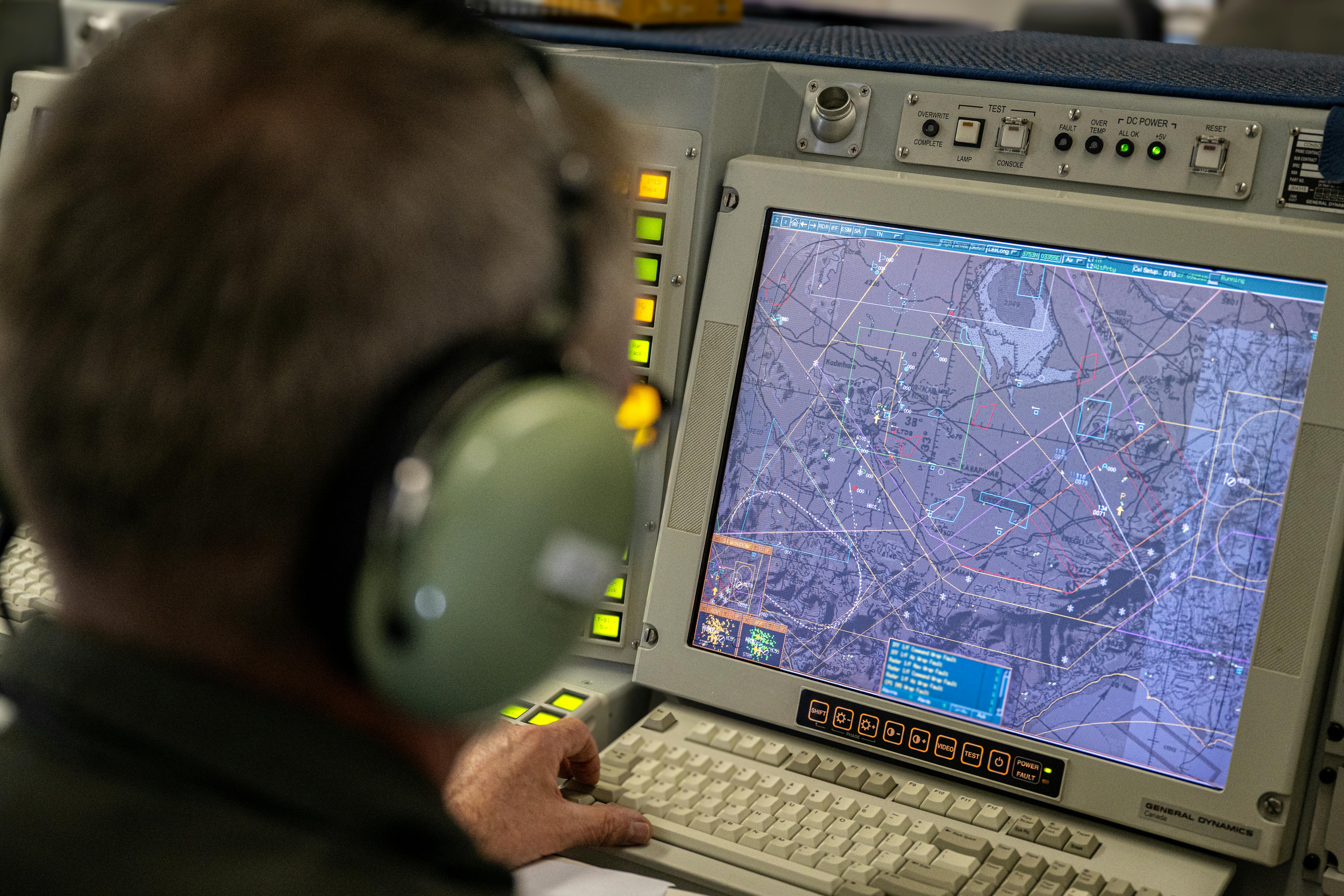 A NATO tactical director operates inside a NATO AWACS aircraft during a military exercise last June.