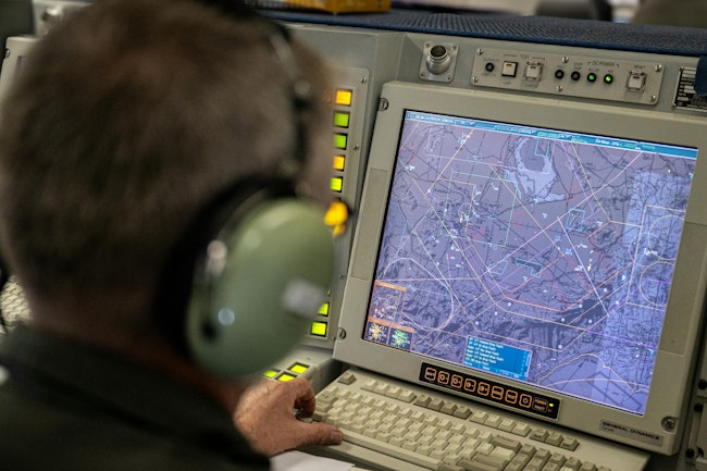 A NATO tactical director operates inside a NATO AWACS aircraft during a military exercise last June.