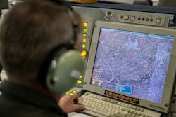 A NATO tactical director operates inside a NATO AWACS aircraft during a military exercise last June. A NATO tactical director operates inside a NATO AWACS aircraft during a military exercise last June.