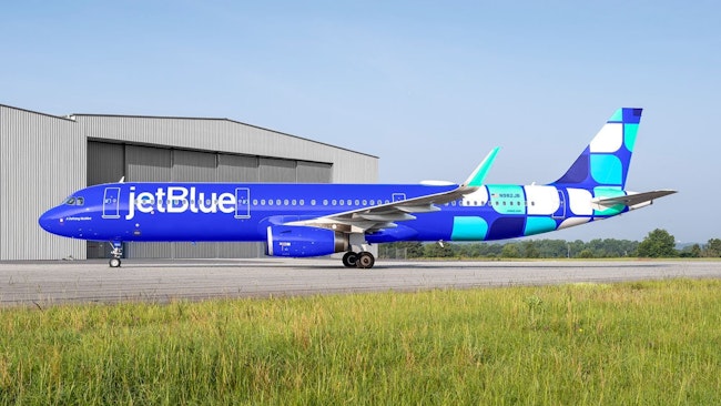 A JetBlue passenger jet on the tarmac of an airport.