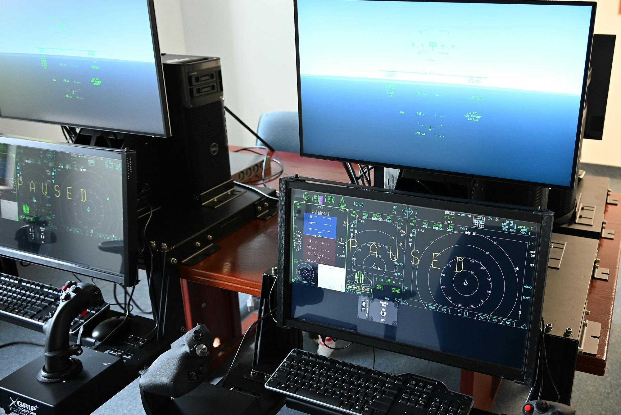 Desktop trainers display naval aviation's new carrier-based joint air training program in a lab at the Naval Air Warfare Center Aircraft Division near its Patuxent River Naval Air Station, Md., in 2024.