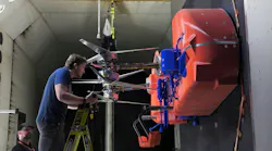 Technicians install and adjust the rotors on the full-scale test model representing half of the Dragonfly lander in the Transonic Dynamics Tunnel facility at NASA’s Langley Research Center. During a month-long testing campaign, the team was able to evaluate rotor system performance in Titan-like conditions. NASA photo.