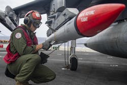 A Marine Corps weapons expert loads an Advanced, Medium-Range, Air-to-Air Missile (AMRAAM), onto a combat jet aboard the amphibious assault ship USS Essex (LHD 2) in February 2022. A Marine Corps weapons expert loads an Advanced, Medium-Range, Air-to-Air Missile (AMRAAM), onto a combat jet aboard the amphibious assault ship USS Essex (LHD 2) in February 2022.