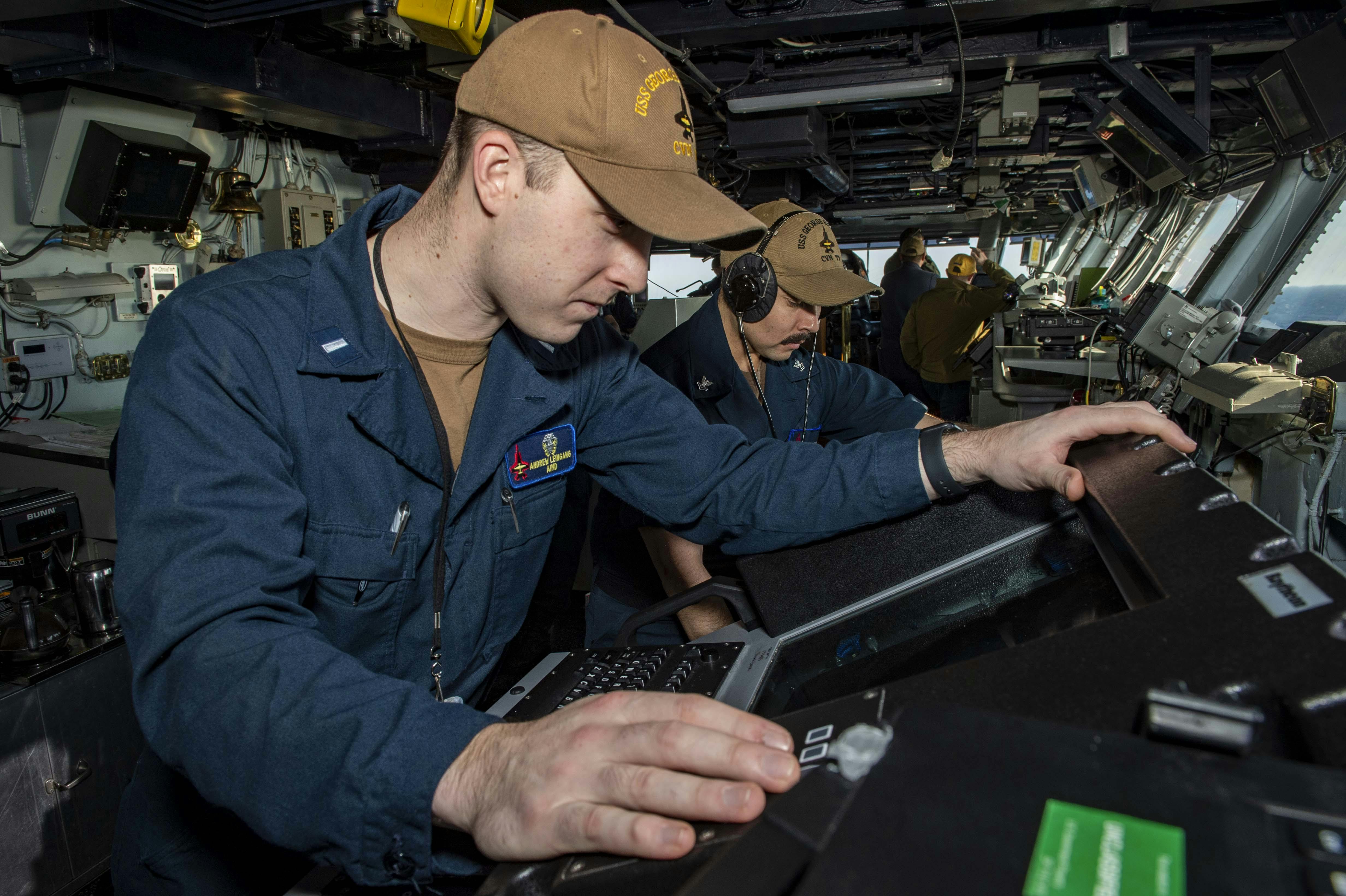 A Navy bridge officer monitors an AN/SPS-73(V) surface-search radar aboard the aircraft carrier USS George H.W. Bush (CVN 77) in March 2022.