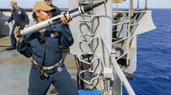A naval officer prepares to launch an Acoustic Device Countermeasure (ADC) torpedo countermeasure from the bridge wing of the amphibious dock landing ship USS Ashland (LSD 48) during a 2019 training exercise. A naval officer prepares to launch an Acoustic Device Countermeasure (ADC) torpedo countermeasure from the bridge wing of the amphibious dock landing ship USS Ashland (LSD 48) during a 2019 training exercise.