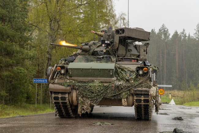 The U.S. 7th Cavalry Regiment starts a simulated firefight while in a M2A4 Bradley Fighting Vehicle during Exercise Hedgehog 25 near Camp Reedo, Estonia, last May 2025.