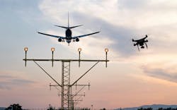 Drone flying at the airport near an aircraft leading to a possible crash or accident. Illegal UAV flight inside the airport conceptual montage Drone flying at the airport near an aircraft leading to a possible crash or accident. Illegal UAV flight inside the airport conceptual montage