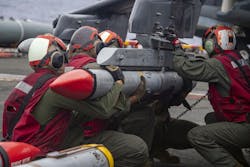 U.S. Marines load an Advanced, Medium-Range, Air-to-Air Missile (AMRAAM), onto an AV-8B Harrier aboard the Wasp-class amphibious assault ship USS Essex (LHD 2) in February 2022. U.S. Marines load an Advanced, Medium-Range, Air-to-Air Missile (AMRAAM), onto an AV-8B Harrier aboard the Wasp-class amphibious assault ship USS Essex (LHD 2) in February 2022.