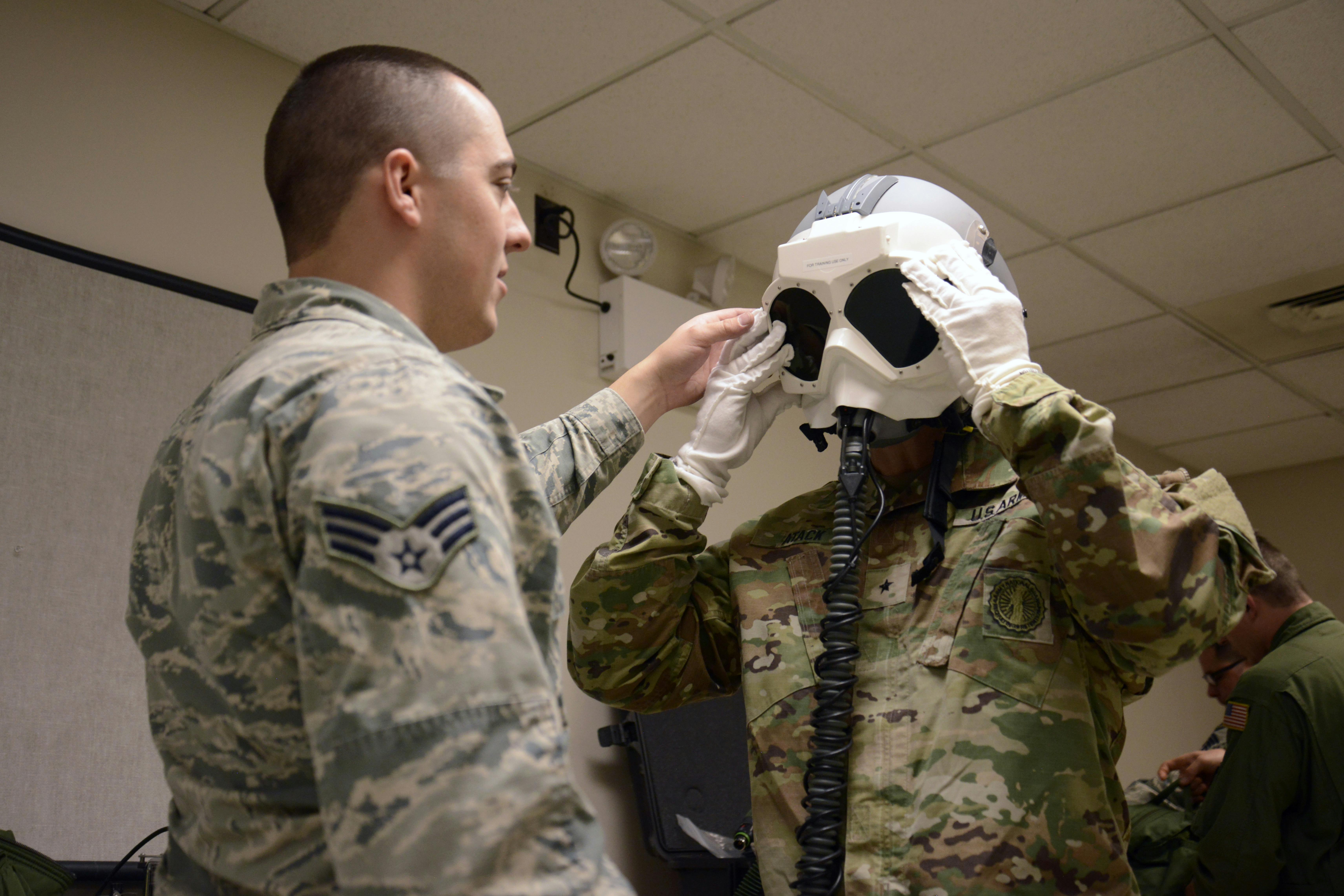 A U.S. Air National Guard aircrew flight equipment specialist demonstrates the anti-flash capabilities of some polarized lead lanthanum zirconate titanate (PLZT) goggles during a 2017 exercise.