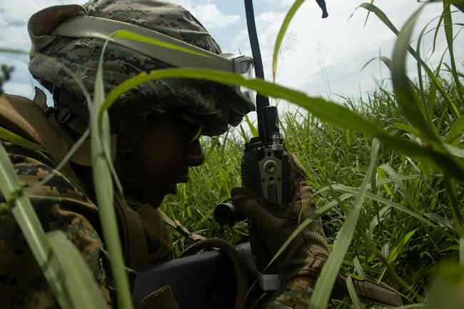 A U.S. Marine Corps expeditionary fuel technician establishes communications using a radio as part of an exercise at Ie Shima, Okinawa, Japan, last May.