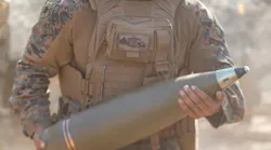 A U.S. Marine Corps howitzer section chief loads a high-explosive projectile into an M777A2 medium towed 155-millimeter howitzer during a 2024 field exercise.