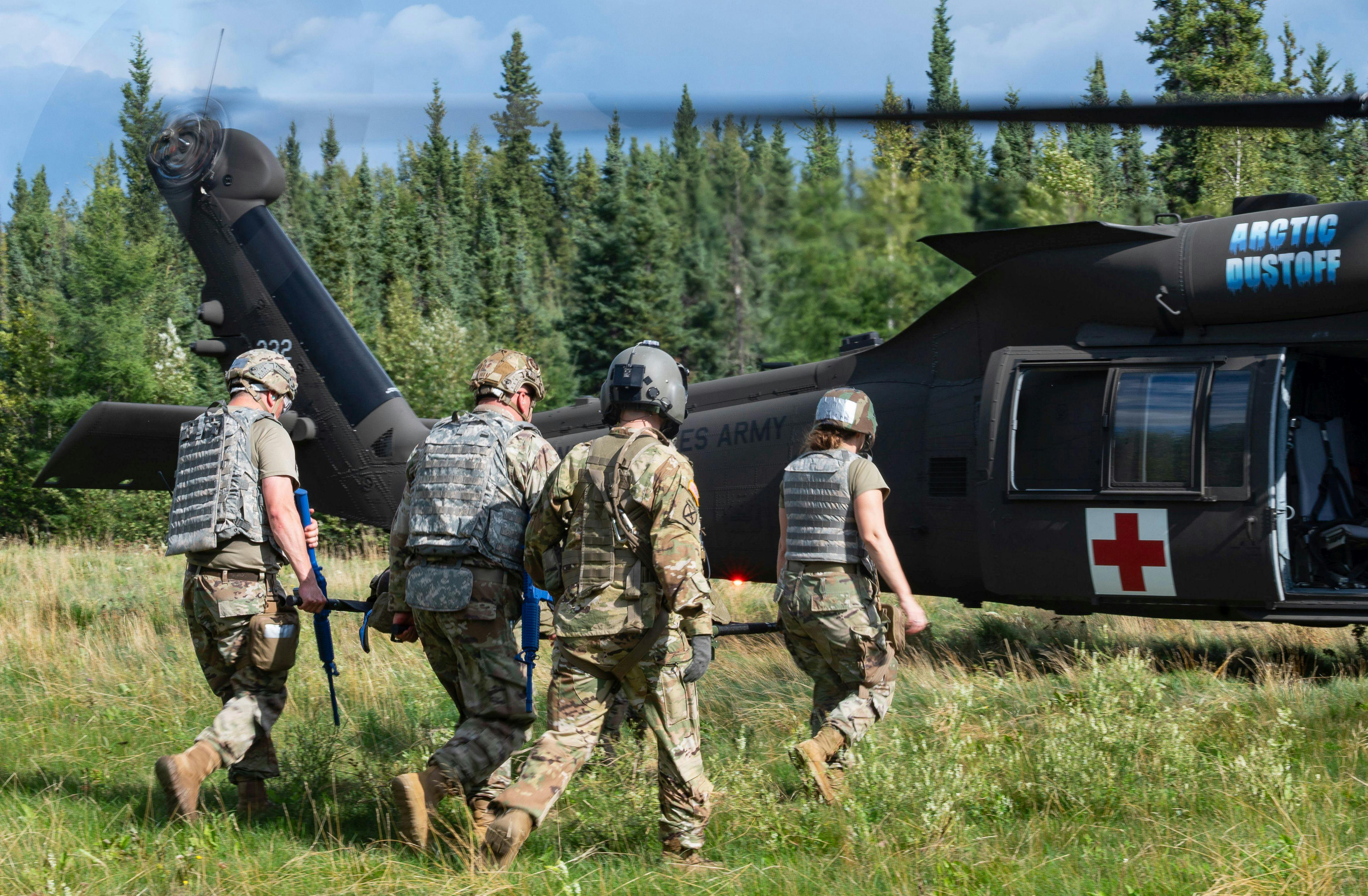 Tactical Combat Casualty Care (TCCC) students offload patients from a UH-60 Black Hawk helicopter during advanced training at Fort Wainwright, Alaska, last August.