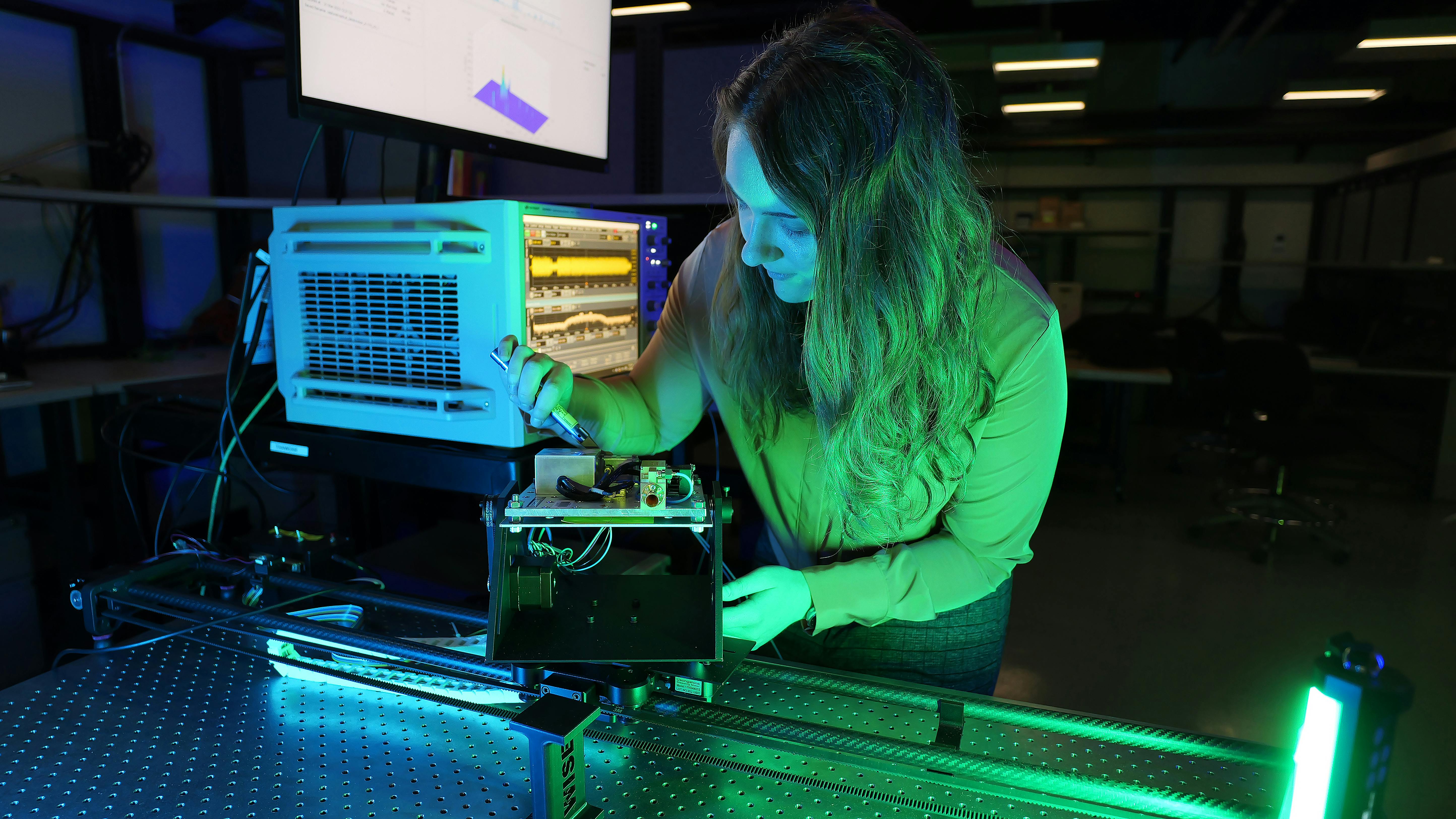 Air Force researcher Clair Parisi measures channel impulse response at 140 GHz on an experimental communications radio. The Air Force Research Lab is leading the area of wireless communications in underused parts of radio spectrum such as frequencies above 100 GHz.