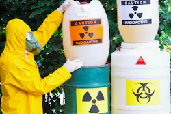 Working with hazardous materials. Chemist with the gas mask and the protective suit the disposal of radioactive waste.