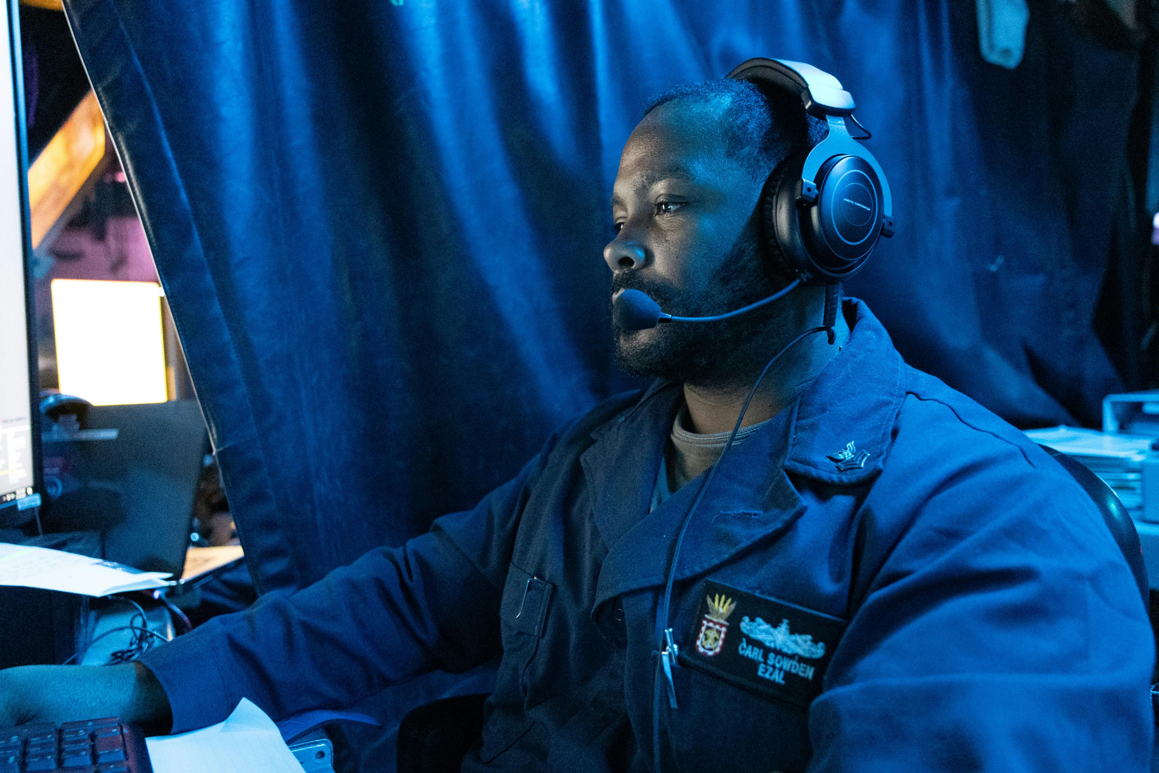 A Navy operations specialist monitors a console in the combat information center of the Arleigh Burke-class guided-missile destroyer USS Curtis Wilbur (DDG 54) during a ballistic missile defense exercise last September.