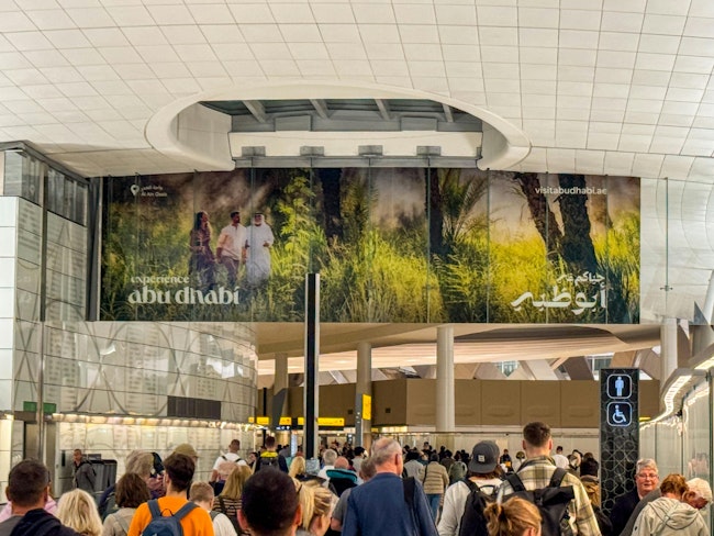 A crowd of passengers walk through the Zayed airport in Abu Dhabi.