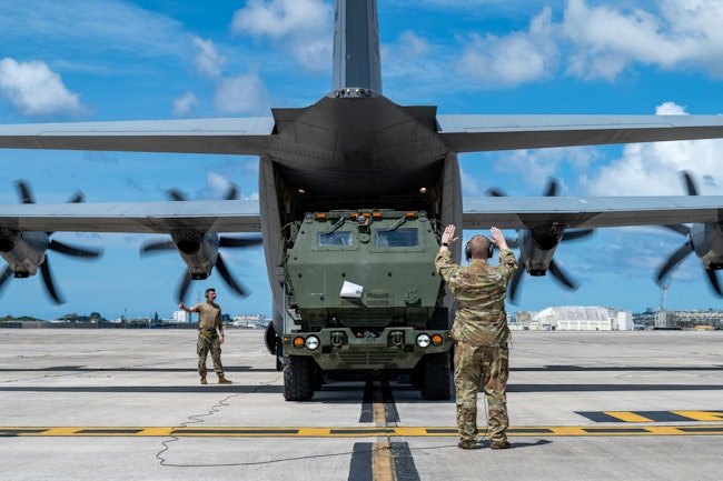 A U.S. Air Force instructor loadmaster guides a U.S. Marine Corps High Mobility Artillery Rocket System into a C-130J Super Hercules. Modern test equipment enables technology to be serviced while deployed rather than being sent back to the home front. Air Force photo