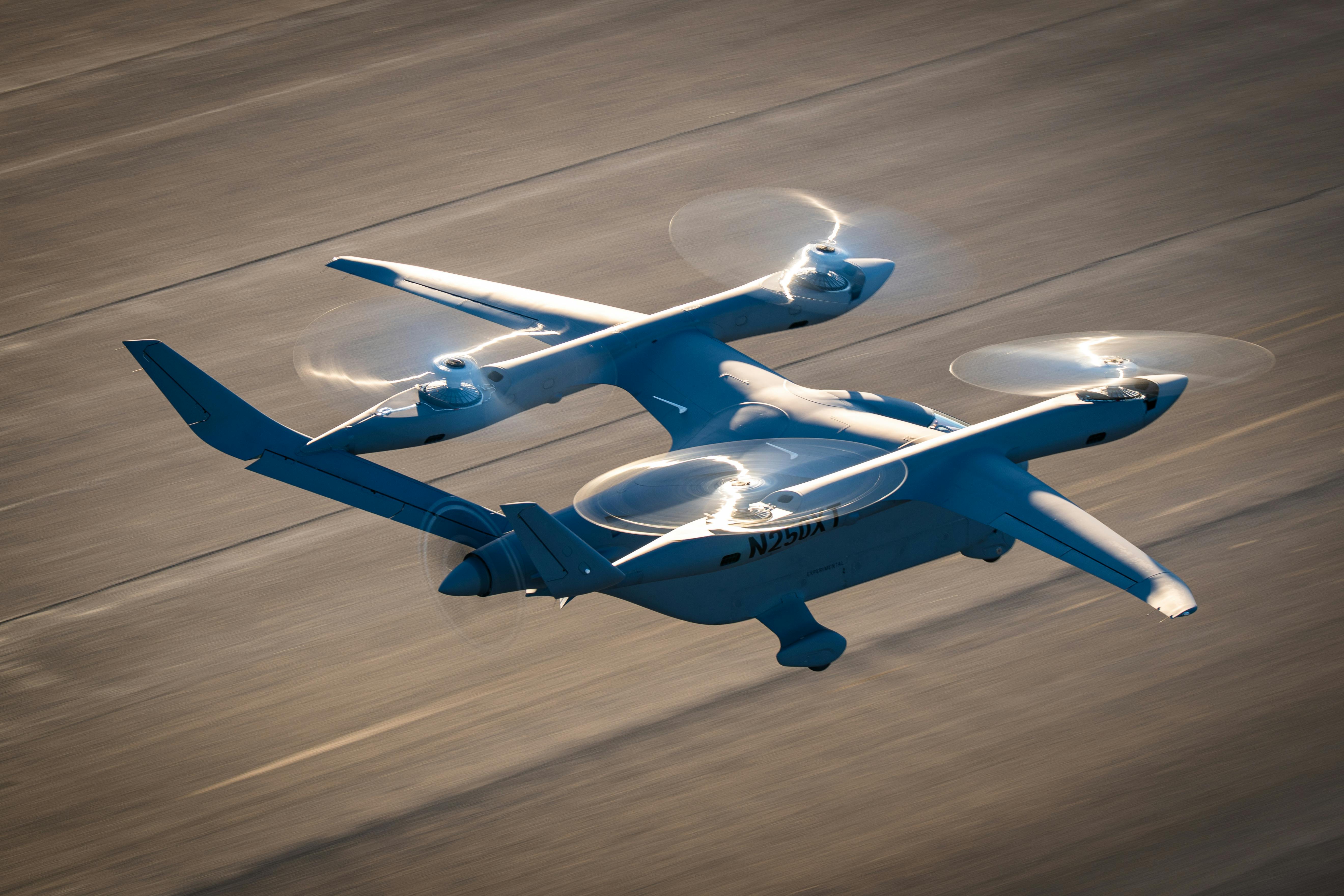 BETA's Alia quad-rotor eVTOL hovers over tarmac.