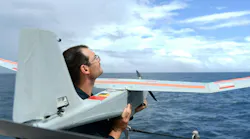 A Navy electronics technician prepares to launch the PUMA AE short-range tactical uncrewed aircraft from the Cyclone-class coastal patrol ship USS Tornado (PC 14).