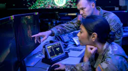 A U.S. Army mission director for the National Space Defense Center points to a screen in front of a U.S. Space Force weapons and tactics section chief at Schriever Space Force Base, Colo., in October 2022.