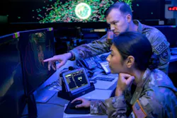 A U.S. Army mission director for the National Space Defense Center points to a screen in front of a U.S. Space Force weapons and tactics section chief at Schriever Space Force Base, Colo., in October 2022.