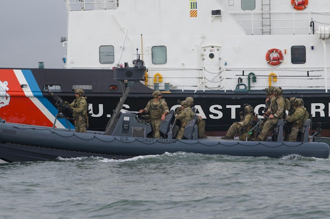 U.S. Coast Guard Maritime Security Response Team (MSRT) members stand guard aboard a rigid-hull inflatable boat (RHIB) alongside a Coast Guard cutter in New York Harbor last September.