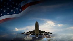 A commercial aircraft flying with a partial American flag waving above it. A commercial aircraft flying with a partial American flag waving above it.