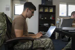 A U.S. Navy cyber warfare technician configures equipment in the Naval Information Warfare Center (NIWC) Pacific 5G lab.