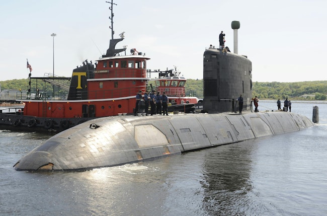 The Canadian Navy Victoria-class long-range patrol submarine HMCS Corner Brook pulls out of her berthing in 2009 at New London Submarine Base, Conn., after a five-day port visit.