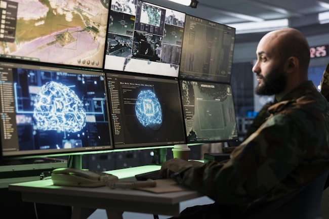 IT specialist uses artificial intelligence to enhance military capabilities. Army software developer employing AI technology in military planning and decision making processes. IT specialist uses artificial intelligence to enhance combat operational capabilities
