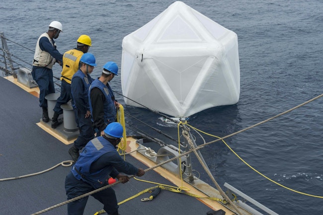 Sailors aboard the Arleigh Burke-class guided-missile destroyer USS Ramage (DDG 61) recover an inflated decoy during an initial test of the Mk-59 decoy launch system in 2014