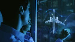 A man and a woman work on a smartboard which displays a commercial airplane. A man and a woman work on a smartboard which displays a commercial airplane.