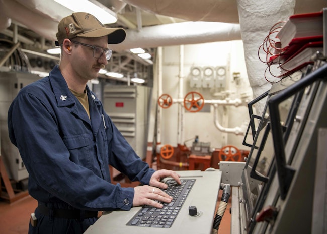 A Navy electronics technician looks over a machinery control system to check for causalities last April aboard the Wasp-class amphibious assault ship USS Makin Island (LHD 8).