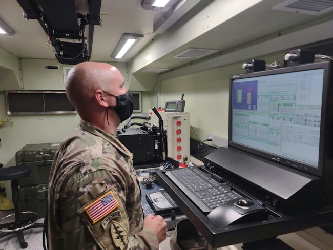 An Army electronic missile systems maintenance technician reads test step procedures during the instrument self-test on the new Next Generation Automatic Test Set at Fort Stewart, Ga., in January 2022.