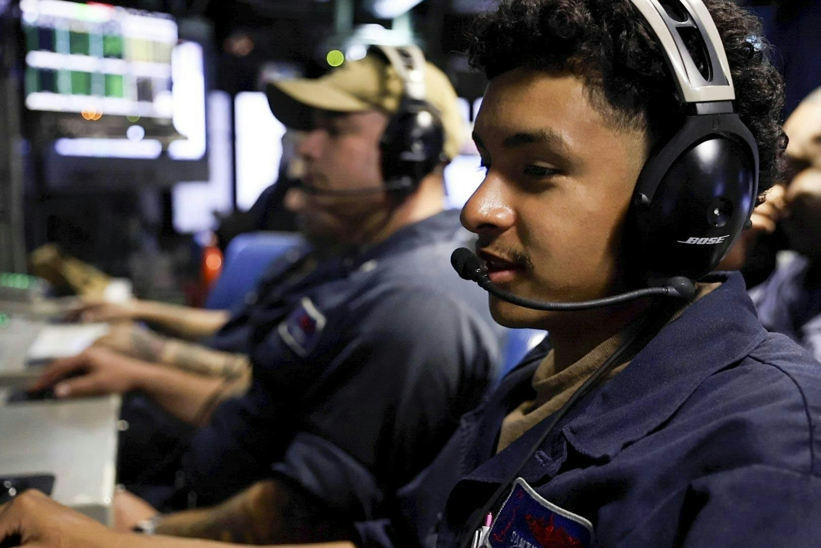 Submarine sonar technicians monitor consoles in the control room of the Virginia-class fast-attack submarine USS New Jersey (SSN 796).
