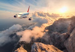 A passenger aircraft flies over mountains A passenger aircraft flies over mountains