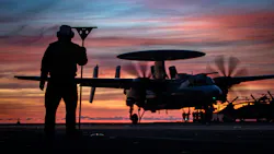 A Navy aviation boatswain’s mate observes a Carrier Air Wing 8 E-2D Hawkeye of Airborne Command and Control Squadron 124, land on the flight deck of the aircraft carrier USS Gerald R. Ford , (CVN 78) last September.