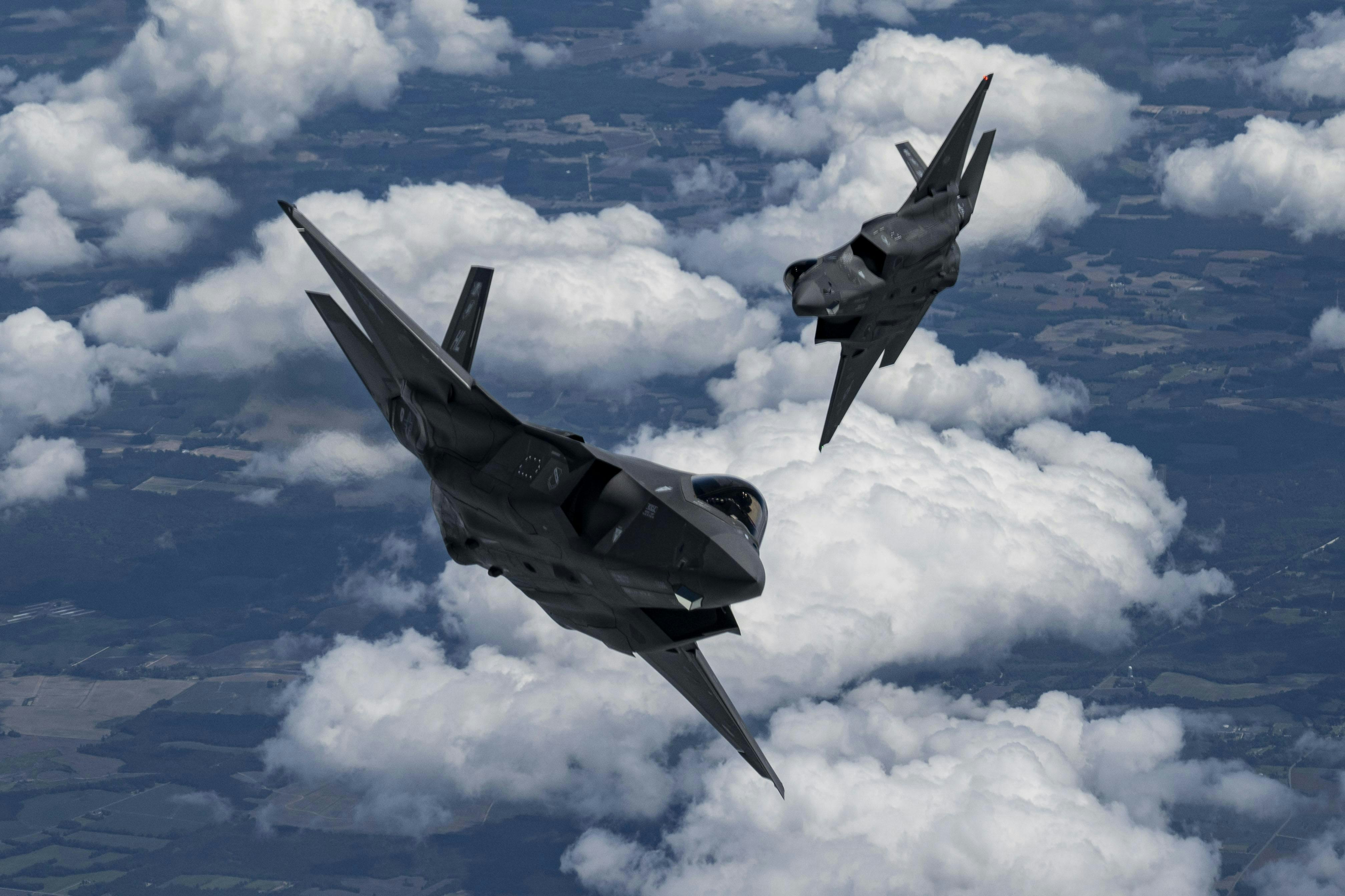 Two U.S. Air Force F-35A Lightning II aircraft fly in formation on the way to perform at the Air and Sea Air Show in Miami in May 2024.