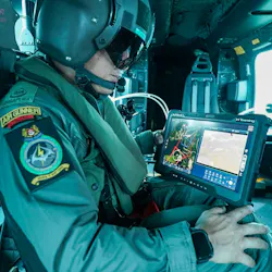 An operator in a helicopter looks at a screen while demonstrating crewed-uncrewed teaming. An operator in a helicopter looks at a screen while demonstrating crewed-uncrewed teaming.