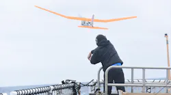 An engineering development technician with AeroVironment Inc. launches a PUMA AE unmanned aircraft from the flight deck of Coast Guard Cutter Polar Star during Operation Deep Freeze 2016.
