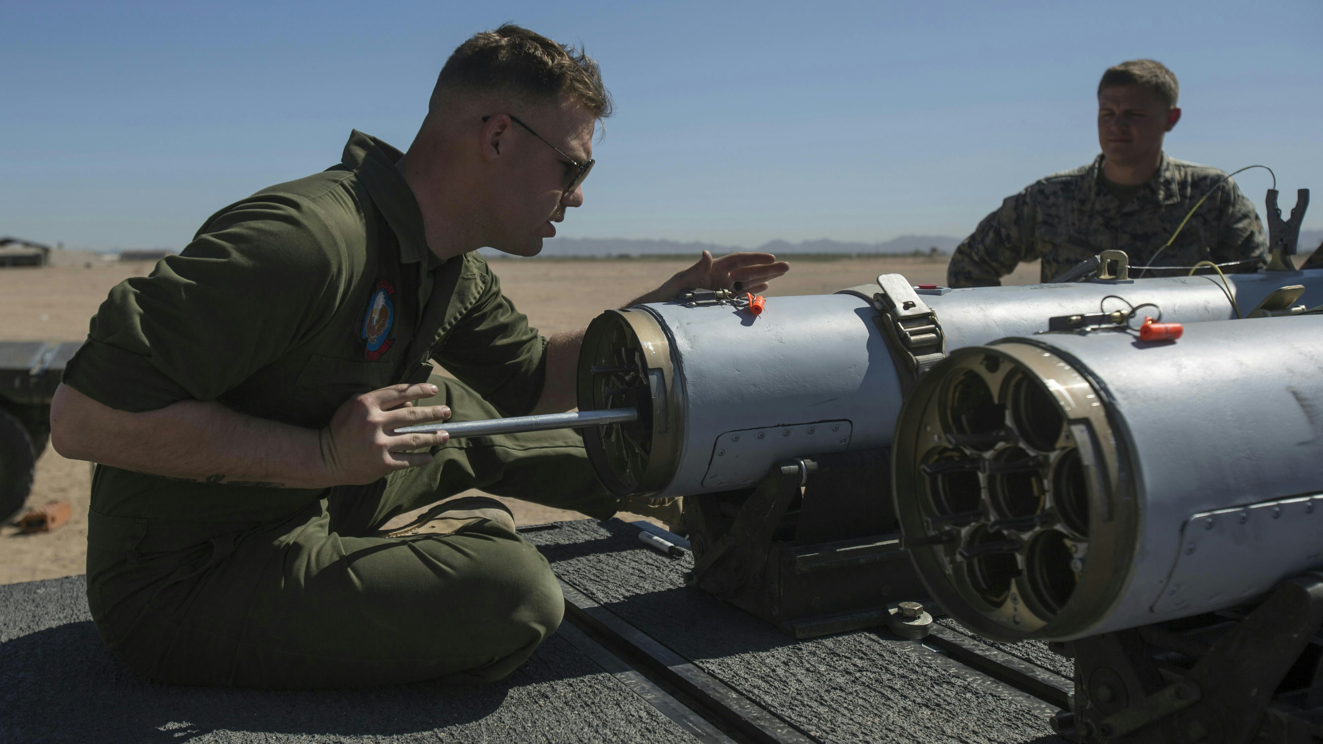 A Marine Corps aviation ordnance system technician loads a 2.75-inch rocket configured with Advanced Precision Kill Weapon System II at Marine Corps Air Station Yuma, Ariz., in 2018.