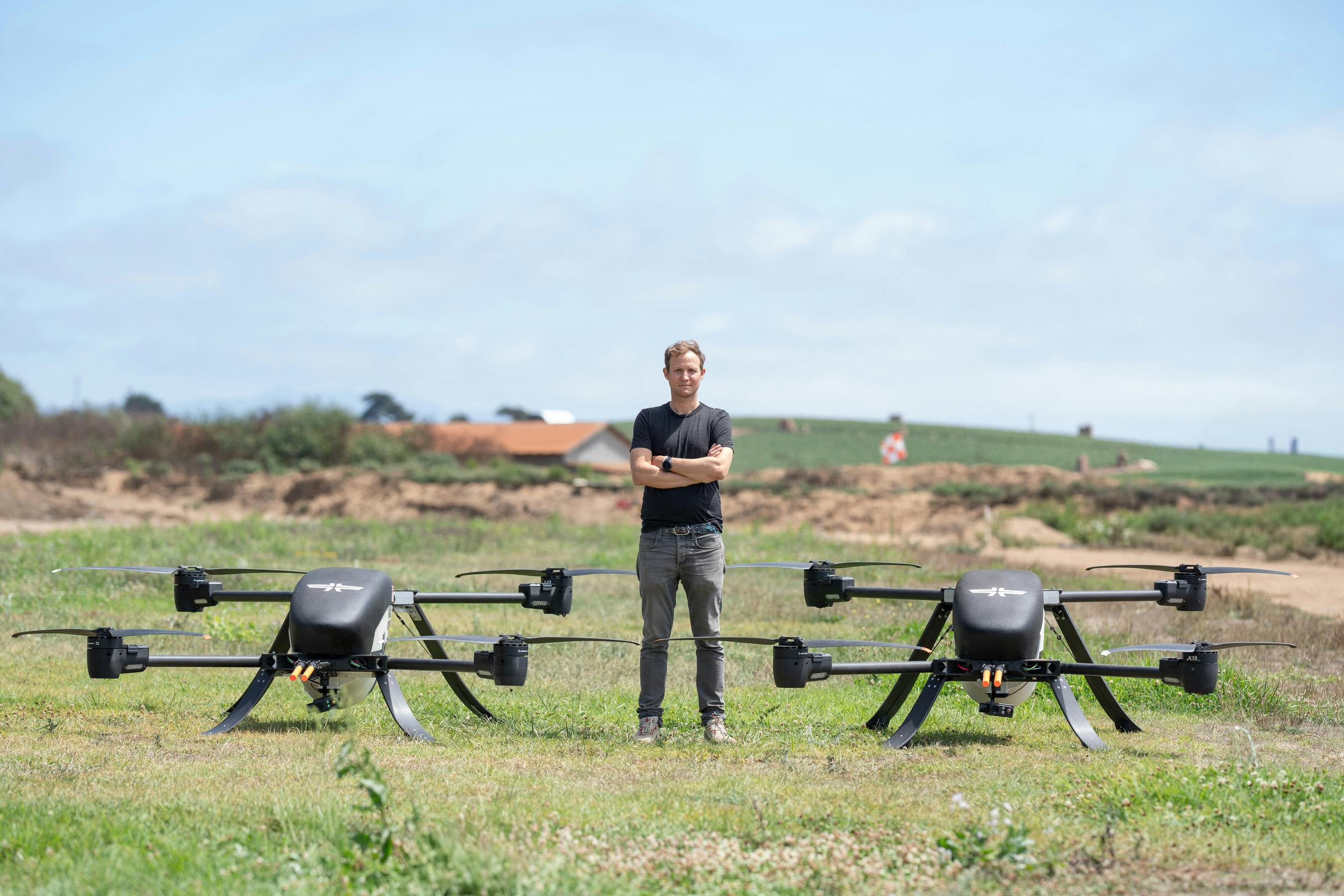 Stuart Landesberg, Seneca Founder and CEO, standing with two autonomous suppression drones. Seneca photo.