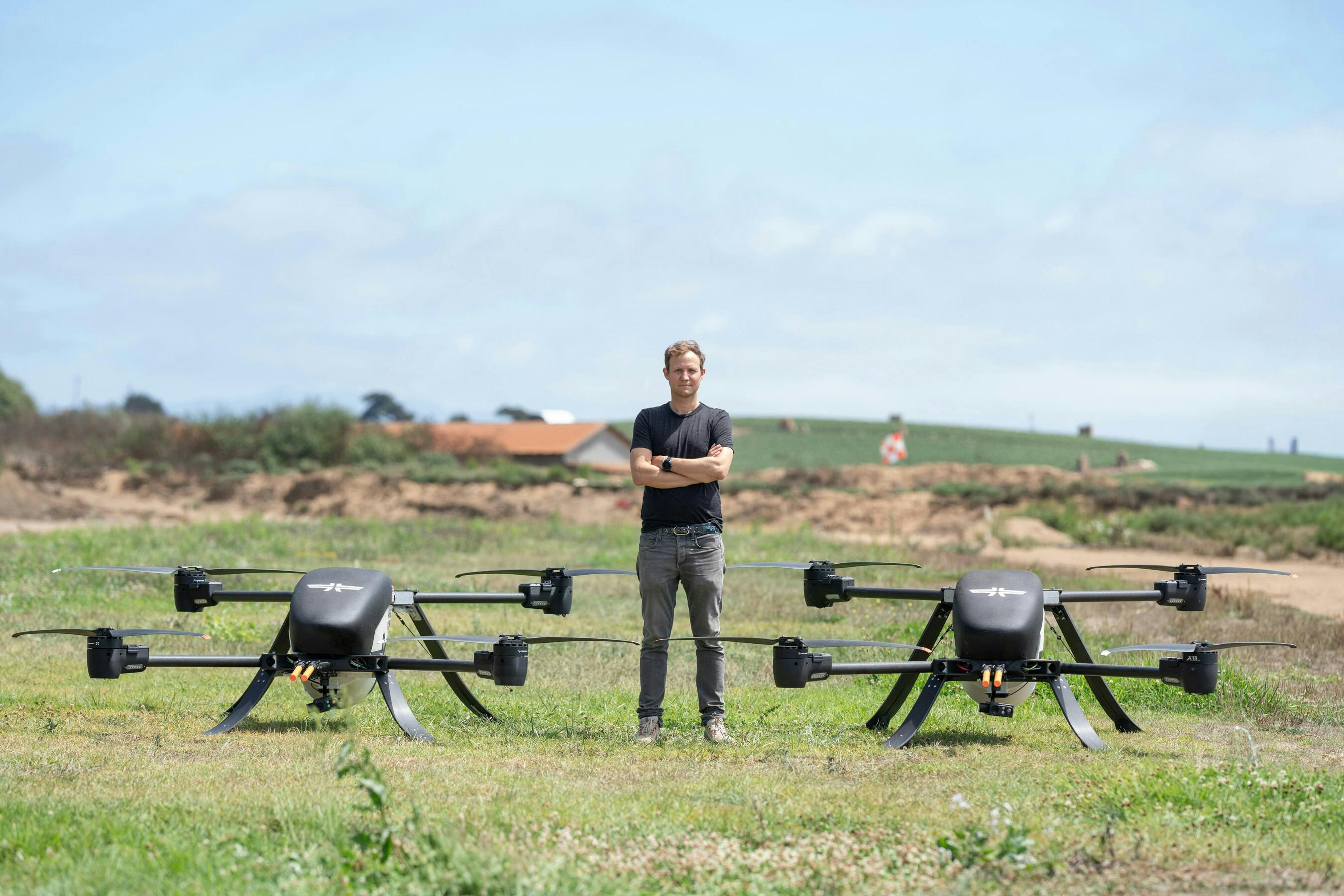 Stuart Landesberg, Seneca Founder and CEO, standing with two autonomous suppression drones. Seneca photo.