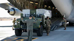 A U.S. Marine maintenance technician backs a Navy/Marine Corps Expeditionary Ship Interdiction System (NMESIS) launcher onto a C-17 Globemaster III at Travis Air Force Base, Calif., in September 2023.