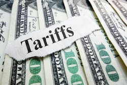 The word 'tariffs' atop spread out $100 U.S. bills. The word 'tariffs' atop spread out $100 U.S. bills.