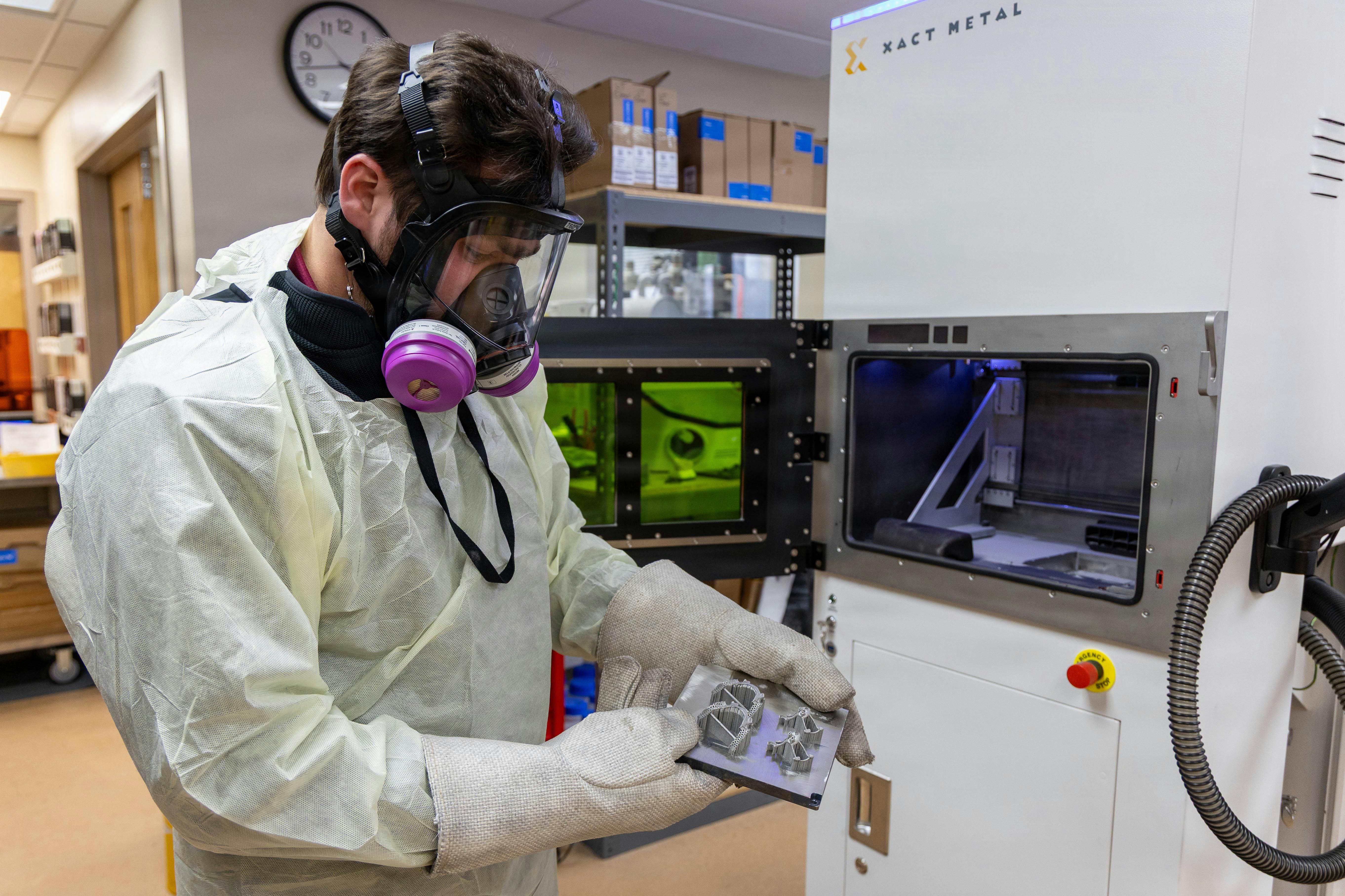 A 3D Medical Applications Center quality engineer, inspects a platform with dental and orthodontic devices that were created using a 3D printer earlier this month at Walter Reed National Military Medical Center in Bethesda, Md.