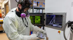 A 3D Medical Applications Center quality engineer, inspects a platform with dental and orthodontic devices that were created using a 3D printer earlier this month at Walter Reed National Military Medical Center in Bethesda, Md.