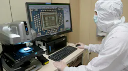 A military electronics engineer performs a visual inspection of a hybrid microcircuit for defects at Robins Air Force Base, Ga., last June.