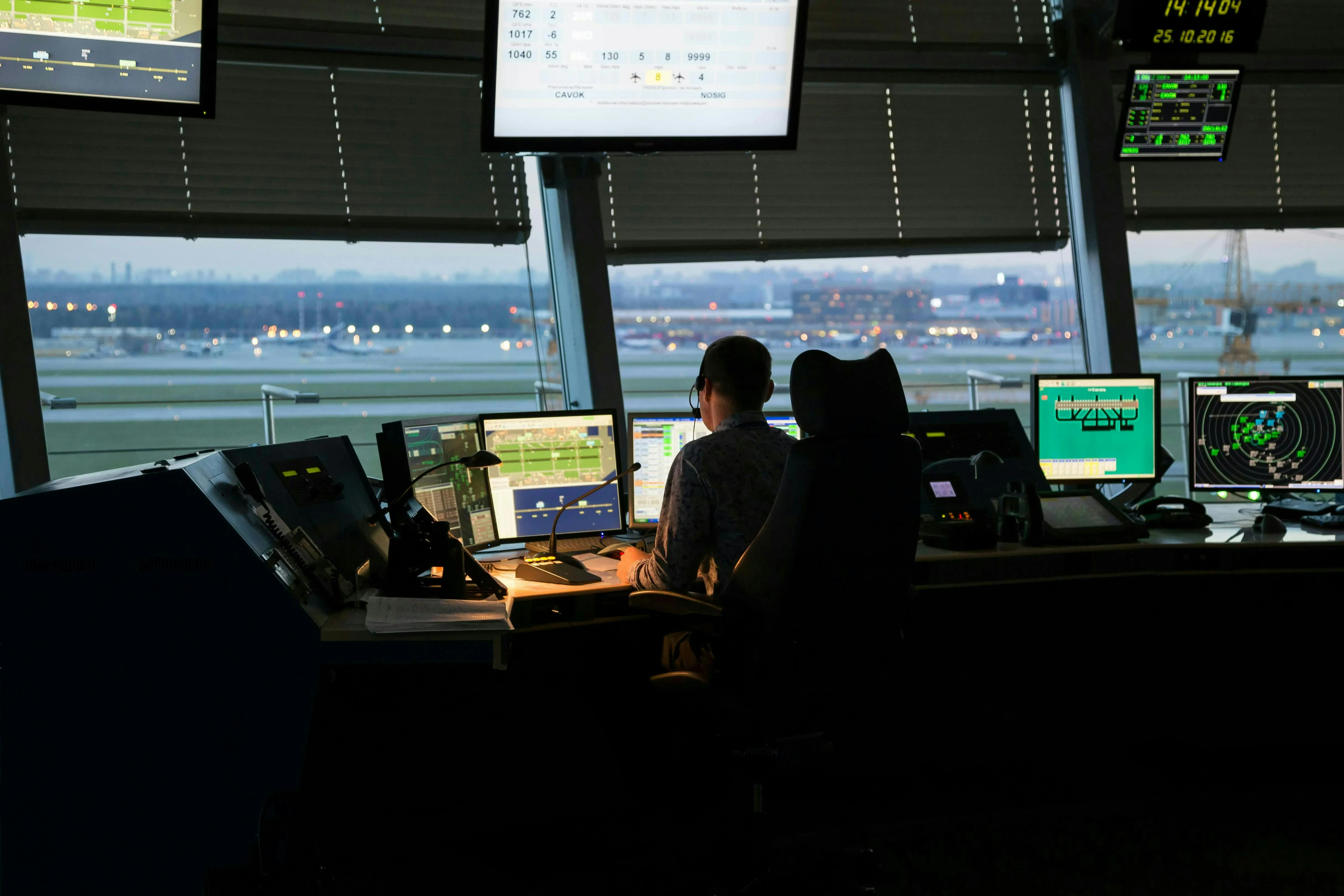 A person works at an air traffic control terminal.