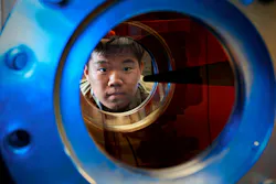 A U.S. Air Force Academy cadet peers through the window of the Department of Aeronautics Hypersonic Mach 6 Ludwieg Tube he tested for class in August 2023. Air Force photo. A U.S. Air Force Academy cadet peers through the window of the Department of Aeronautics Hypersonic Mach 6 Ludwieg Tube he tested for class in August 2023. Air Force photo.